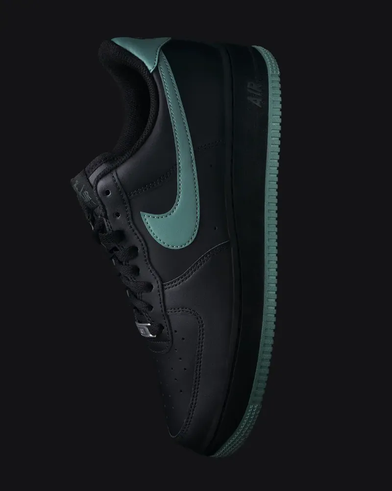 Sneaker nera con logo verde su fondo nero